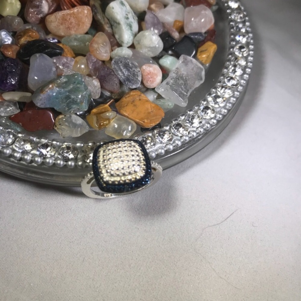 Blue diamonds surrounding cut sterling silver.925